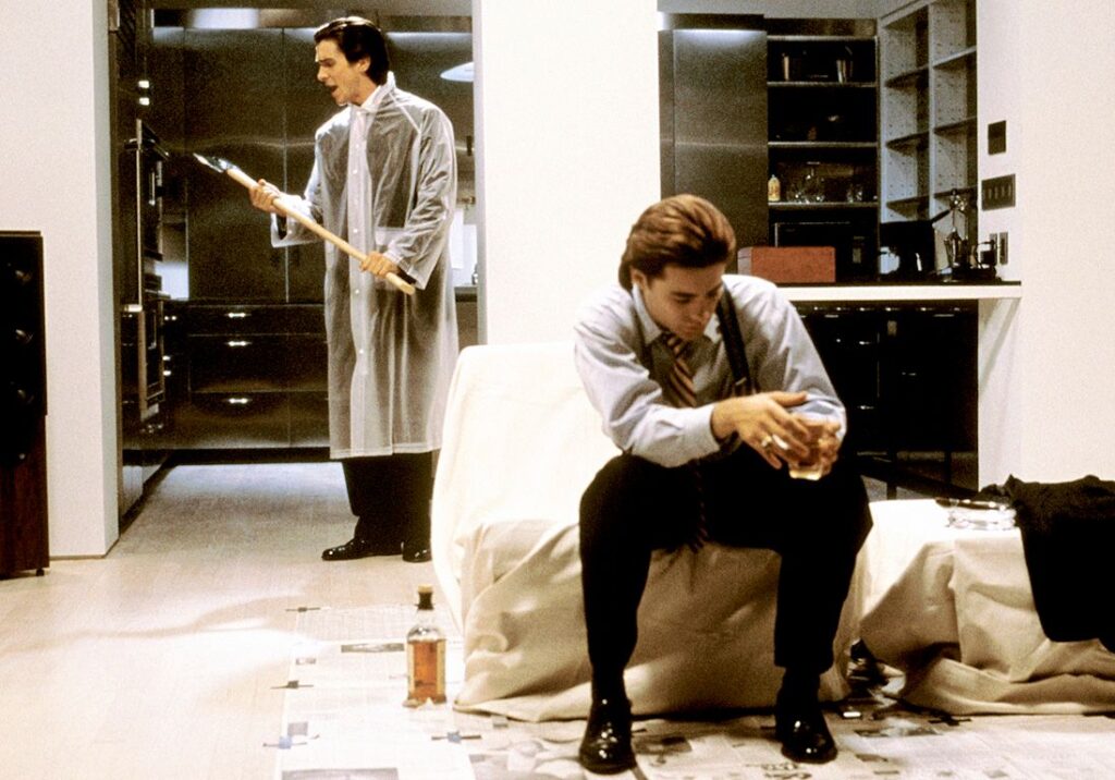 A screenshot from "American Psycho." It shows Patrick Bateman moments before he kills Paul Owen with an axe.