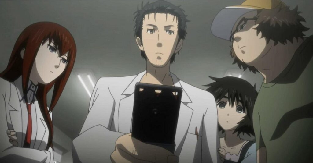 Four scientists gather around one cellphone.